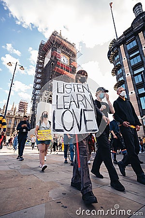 Huge crowd of Black Lives Matters protesters heading to Trafalgar square, chanting and holding listen love learn banners Editorial Stock Photo