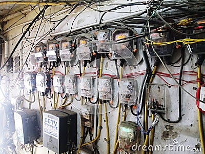 Huge electric meter on one wall power supply wires Editorial Stock Photo