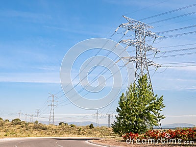 Huge electric tower next to a road and a roundabout Stock Photo