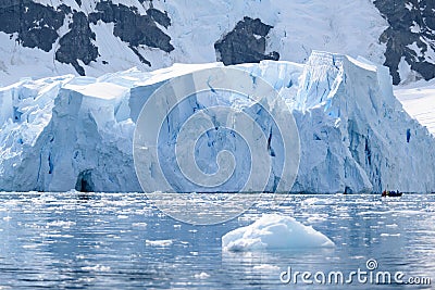 Glacier wall in Antarctica, majestic blue and white ice wall with gate in front. Stock Photo