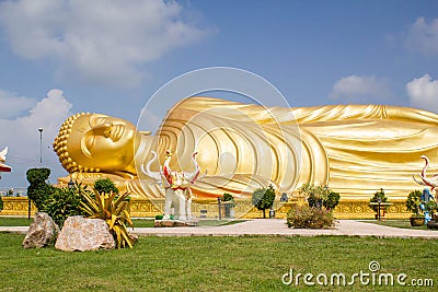 Huge golden sleeping Buddha with blue sky Stock Photo