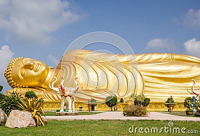 Huge golden sleeping Buddha with blue sky Stock Photo