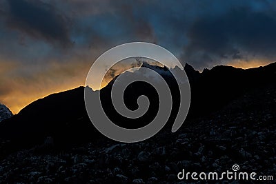 Huge Himalayan mountain with a glaciers in Nepal covered by clouds before the sunrise Stock Photo