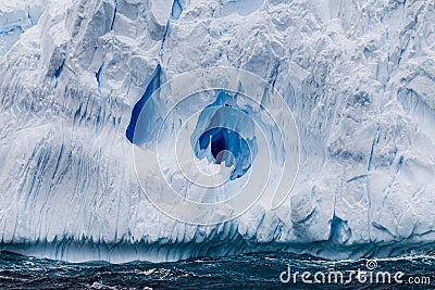 Huge iceberg floats in the turbulent waters surrounding Antarctica Stock Photo