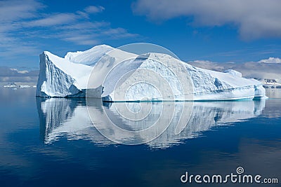 Iceberg in Antarctica, Huge Iceberg with Reflections in Calm Unruffled Ocean Water Stock Photo