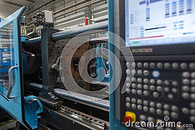 Huge injection molding machine without fixture, ready for the plastic articles by injecting heated material into mold Stock Photo