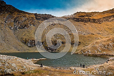 Huge lake in the mountains with a little house on the dock. Nice blue sky with some clouds. Shot in Romania, Transfagarasan Stock Photo