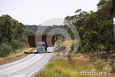 Huge mining dump truck tray transported on highway Editorial Stock Photo