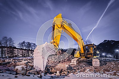 Huge orange shovel digger on demolition site Stock Photo