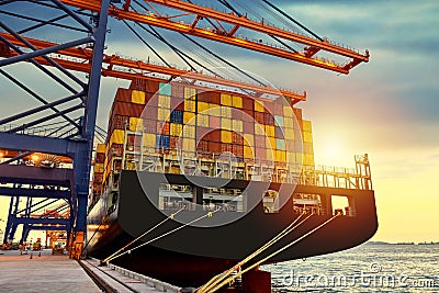 Huge panamax size container vessel discharging and loading container cargo at port terminal. Stock Photo