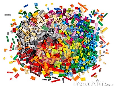 Huge pile of stackable plastic toy bricks top view isolated white background. Colorful texture childhood education and Stock Photo