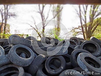 Huge piles from old car tires under a bridge in Varna, Bulgaria. Pollution all around. Editorial Stock Photo