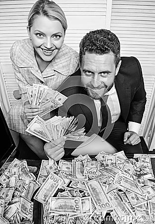 Huge profit concept. Financial success. Man businessman and woman secretary with pile dollar banknotes. Profit and Stock Photo