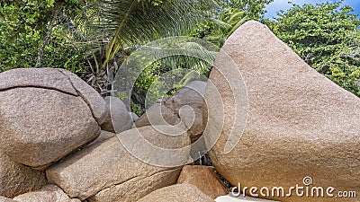 Huge rounded granite boulders on the white sand of the beach. Stock Photo