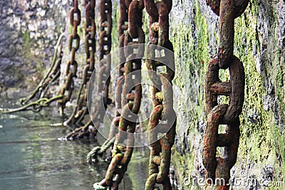Huge rusted and mossy chains Stock Photo