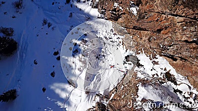 A huge snow cliff. Flows down the waterfall. Huge icicles and ice. Stock Photo