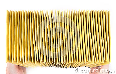 Huge stack of yellow mailing envelopes in hands, top view, isolated on white Stock Photo