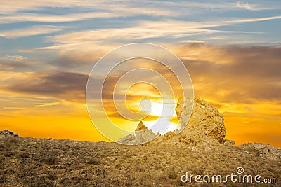 Huge stone in a prairie on a sunset background Stock Photo