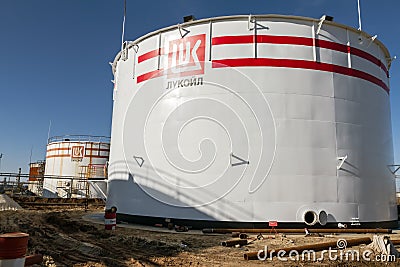 Huge storage tanks for petroleum products with the logo of LUKOIL Editorial Stock Photo