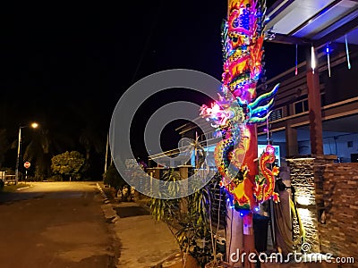 The huge unburned joss stick light up the night scene outside the house. Editorial Stock Photo