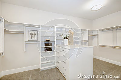 Huge walk-in closet with shelves, drawers and clothes rails Stock Photo