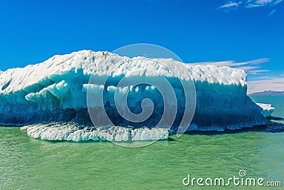 The huge white-blue iceberg floats Stock Photo