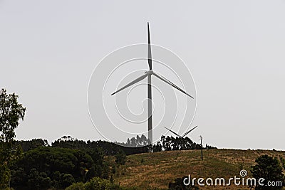 Huge windmill turbines in the Algarve region generate electricity Editorial Stock Photo
