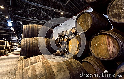 Huge winery with oak barrels full of vintage port wine Editorial Stock Photo