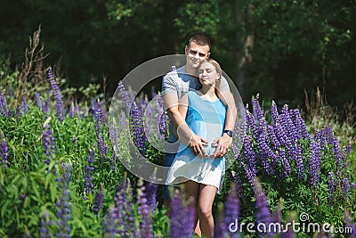 Hugging young pregnant couple Stock Photo