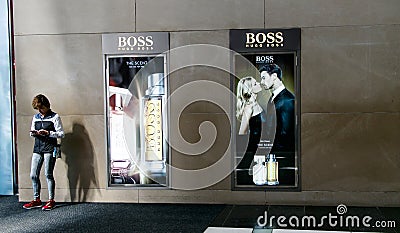 Hugo Boss adverts plus woman on the phone Editorial Stock Photo