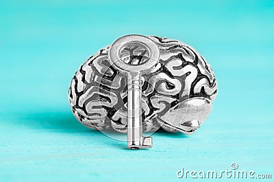 Human brain and master key isolated on blue Stock Photo