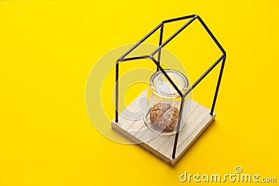 Human brain under glass flask isolated in house on yellow background. Self-closure, stress and depression. lack of communication Stock Photo
