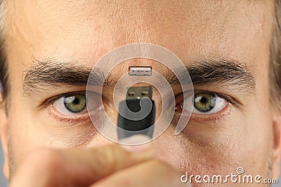 Human connects wire to the connector on his face between eyes, closeup, concept Stock Photo