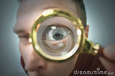 Human eye through a magnifying glass. Stock Photo