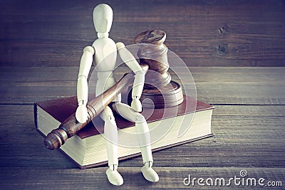 Human Figurine With Judges Or Auctioneer Gavel Sit On Book Stock Photo