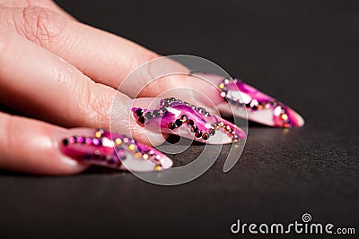 Human fingers with long fingernail over black Stock Photo