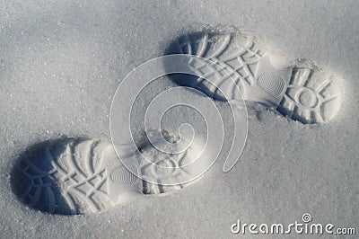 Human footprints boots reflected on the white snow in winter Stock Photo