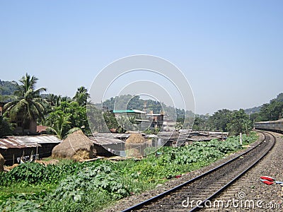 Human habitation nearby railway corridor in India Stock Photo