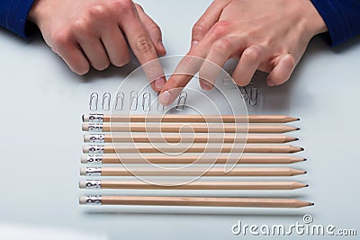 Human Hand Arranging Paper Clips In A Row Stock Photo