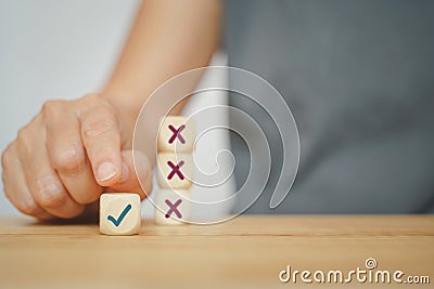 Human hand choose correct sign on wood cube from experience for business, make a decision concept Stock Photo