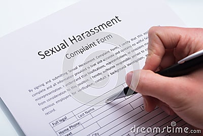 Human Hand Filling Sexual Harassment Complaint Form Stock Photo