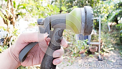 Human hand hold mini shower tree machine with nature background Stock Photo