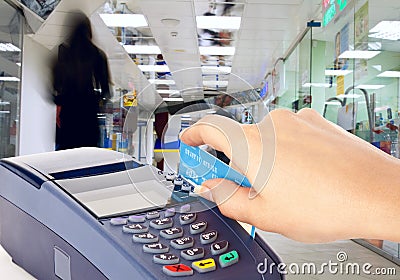 Human hand holding plastic card in payment machine Stock Photo