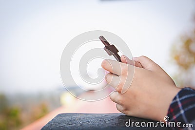 Human hand holds cross. prayer concept for faith, spirituality and religion Christian concept Stock Photo