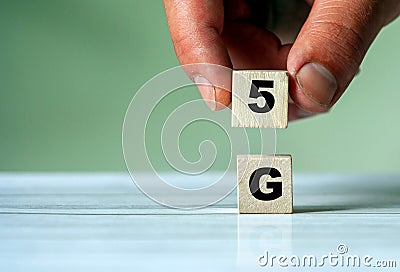 Hand put wooden block and set technology word 5G. Network future. High speed of mobile internet Stock Photo