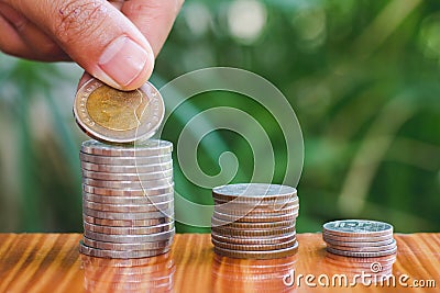 Human hand putting coins money stack step growing growth saving money, deposit Close up of person hand stacking golden coins, Stock Photo