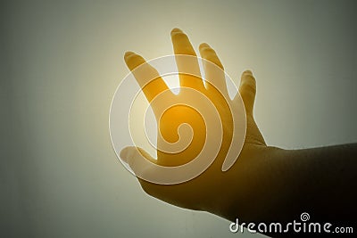 Human hand reaching for the sun Stock Photo