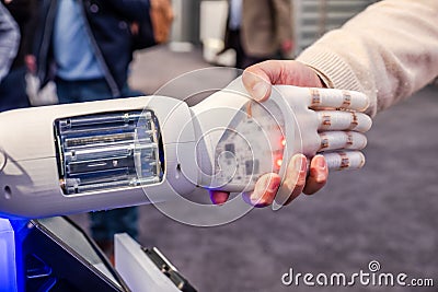 Human hand and robot`s as a symbol of connection between people and artificial intelligence technology Stock Photo