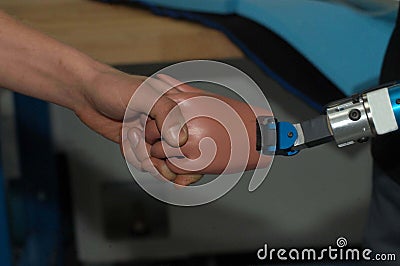 Human hand touches prosthetic hand Stock Photo