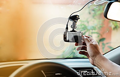 The human hand is touching the CCTV car camera,for check system before use,the technology for car user,for safe and secure driving Stock Photo